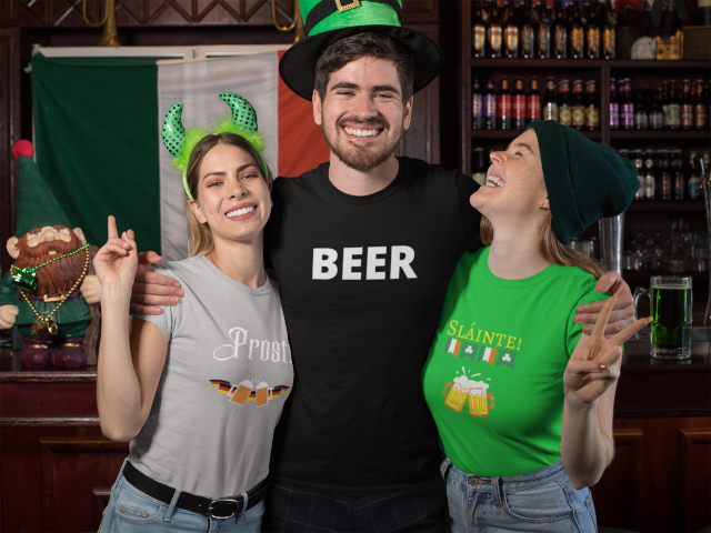 Man wearing shirt with the word 'BEER!' depicted on it. Two women are standing on either side of the man.  Their shirts are also festive drinking shirts, perfect for happy hour.